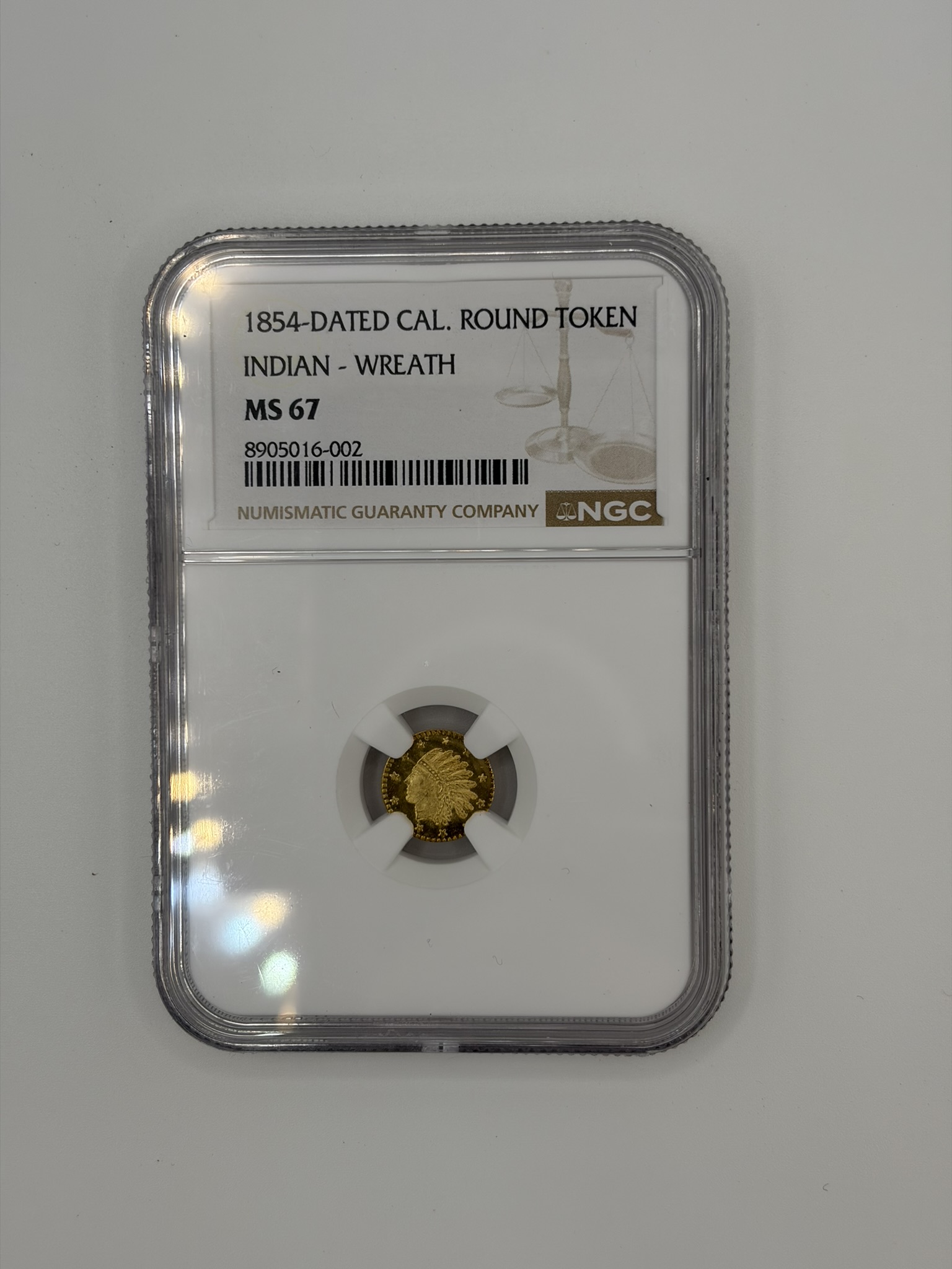 1854 California gold round on the counter at Gold King, Hickory, NC